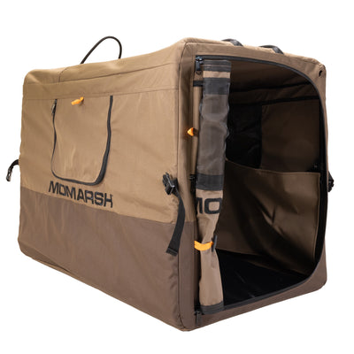 The MOmarsh Quick Crate by MOmarsh Inc. is a portable, brown and tan soft-sided dog crate with mesh ventilation, a zippered door, and collapsible design—ideal for pet transport or shelter.